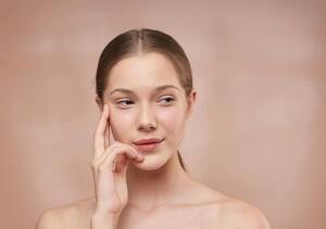 woman holding her face